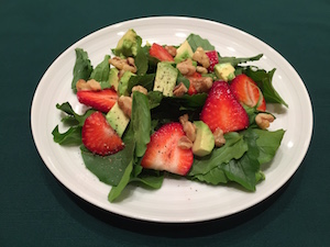 Vegan arugula, strawberry, avocado, walnut salad